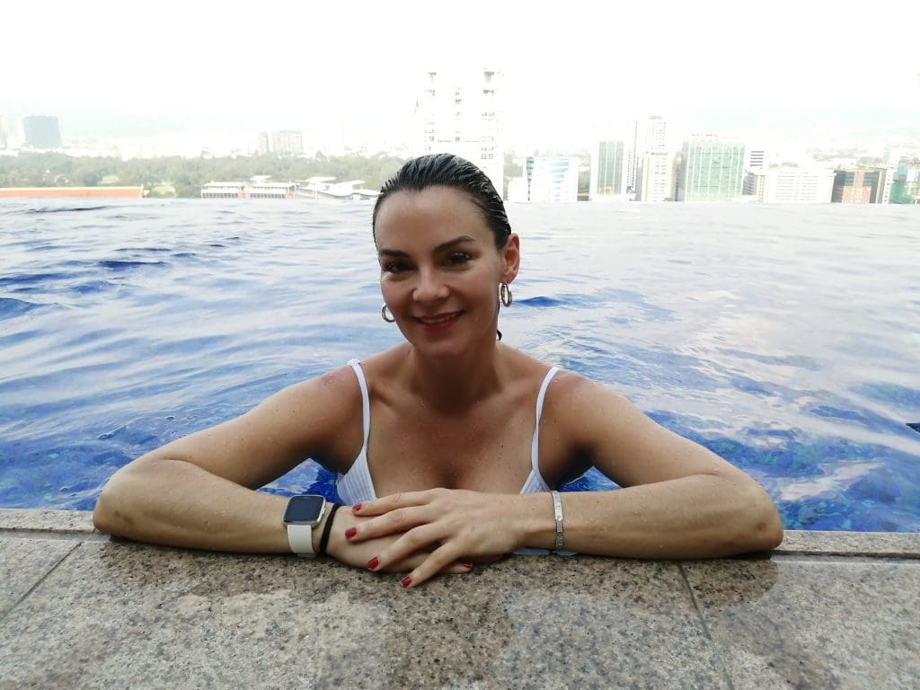woman in a pool overlooking a city.