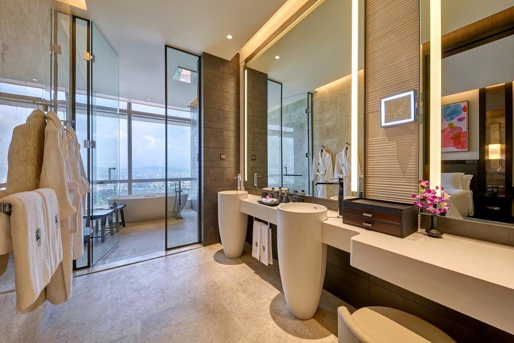 luxury bathroom in luxury hotel showing mirris, sinks and views.