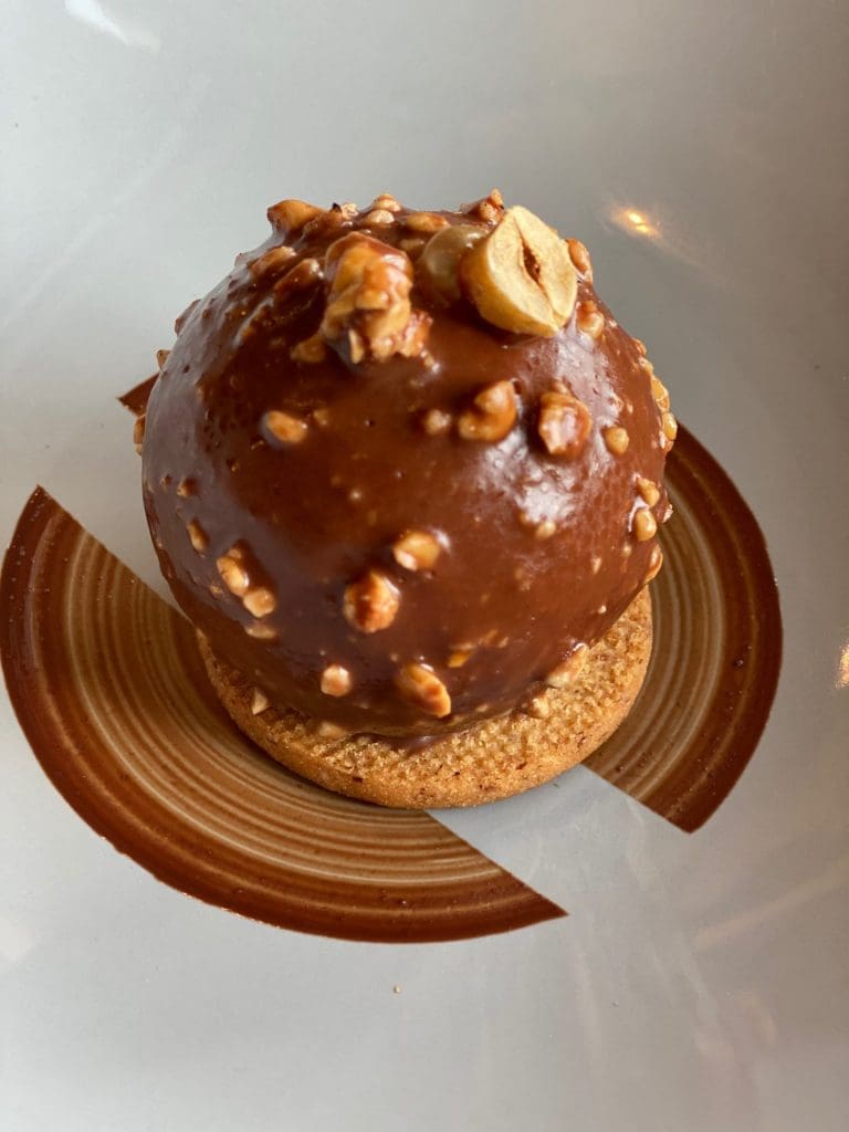 chocolate call with hazelnuts and on a biscuit base beautifully presented on a plate