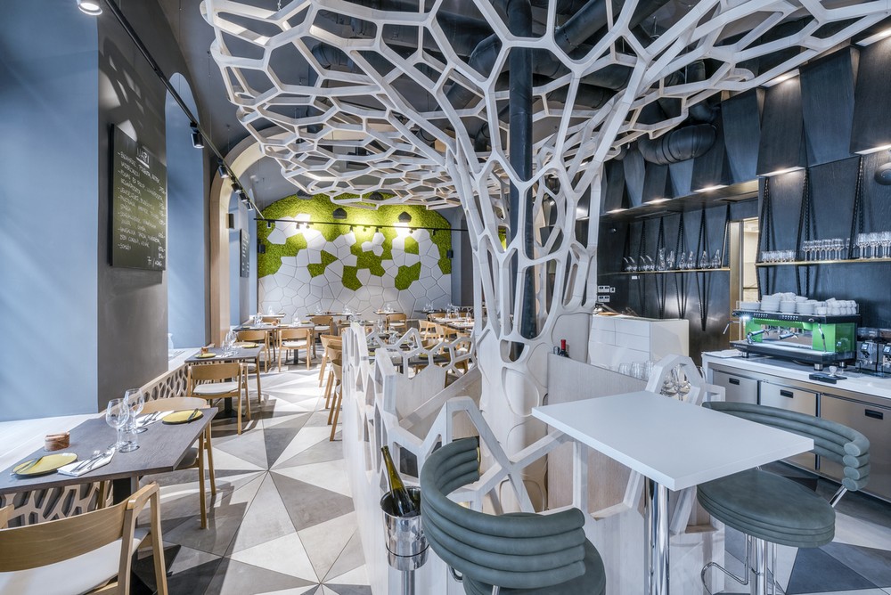 Amazing interiors with a white tree with netting styles holes all over it, white tables 