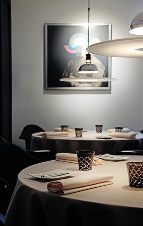 Elegant restaurant with table cloths and art on the wall