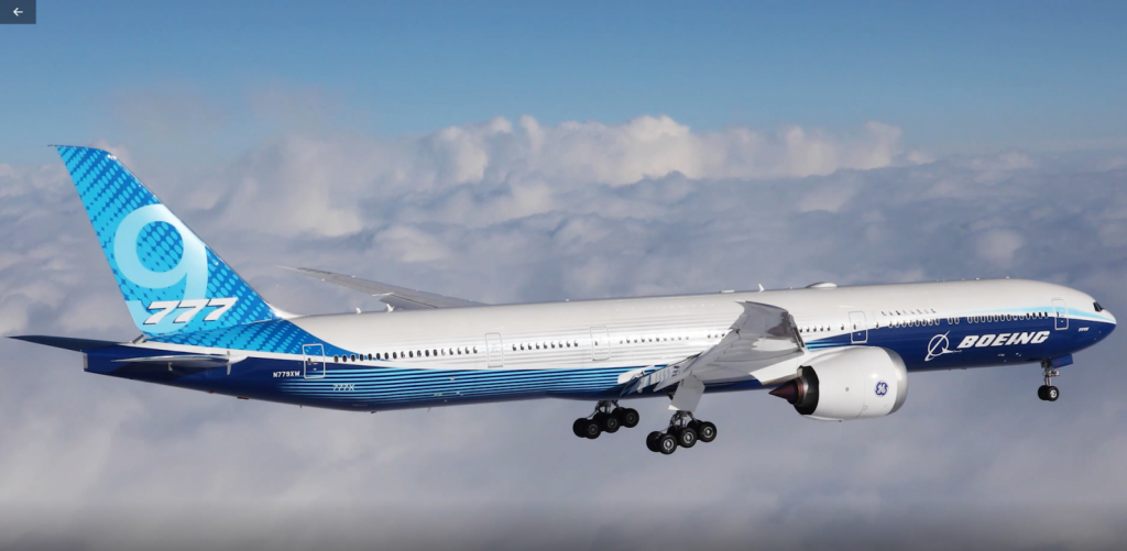 An image of the Boeing 777X plane in the sky 