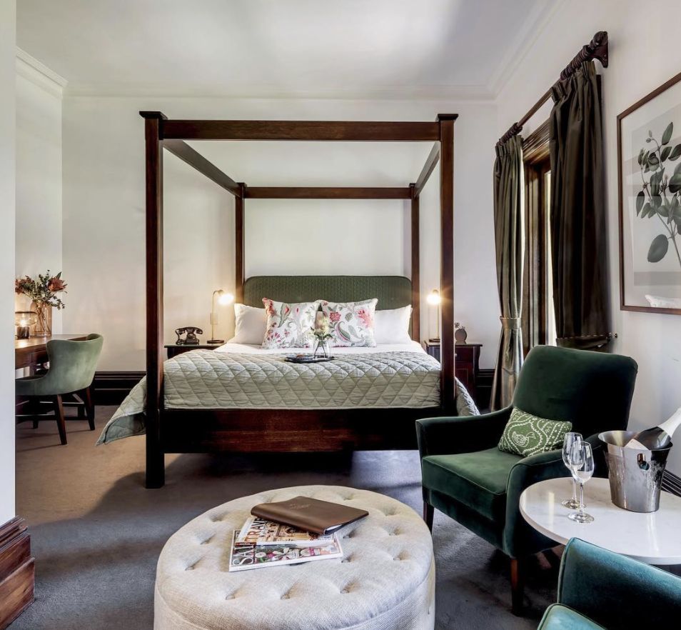 a bedroom with chairs at Mount Lofty House in Adelaide