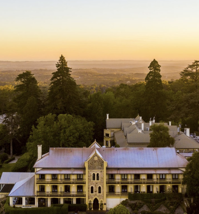 A sunset at Mount Lofty House with trees and building in Adelaide