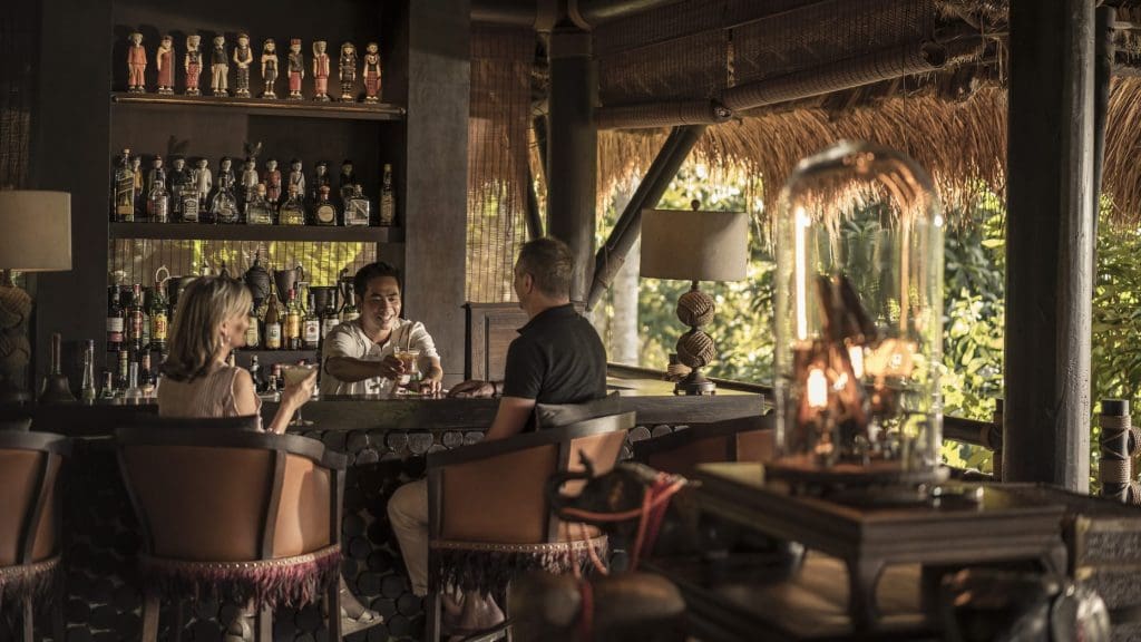 A couple enjoying a drink as the bar tender serves it up inside the Burma Bar