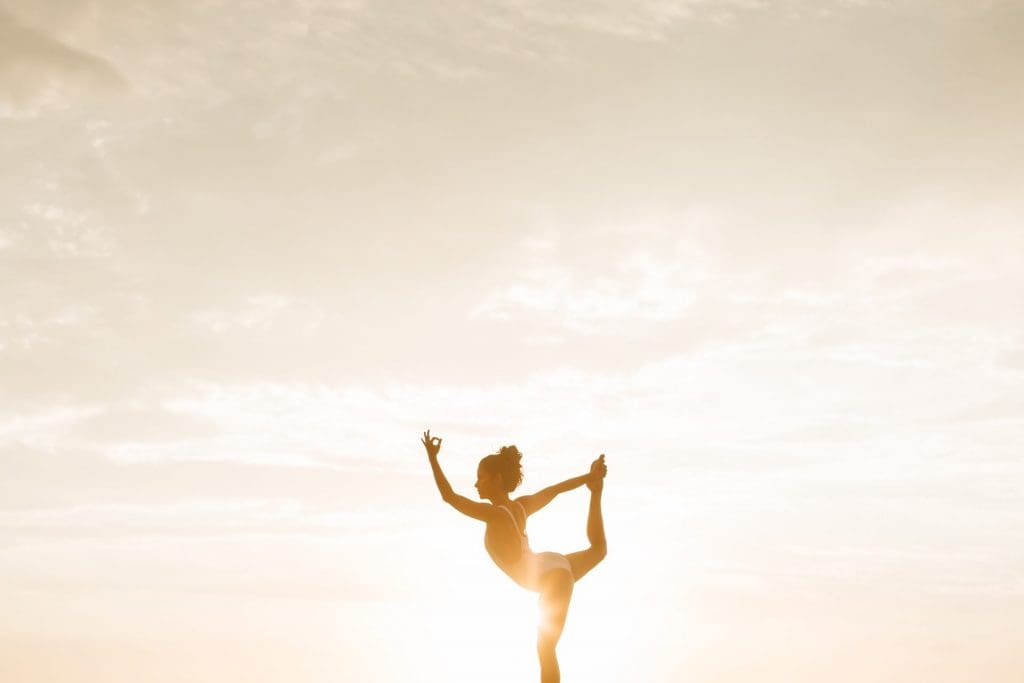 woman doing yoga in the sun. Travel tips