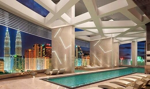Image of swimming pool at Banyan Tree with view of city's skyline.